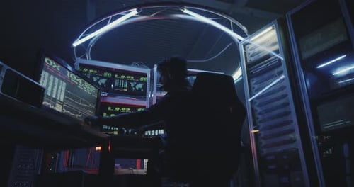 Person Working at Computer Station in Data Center