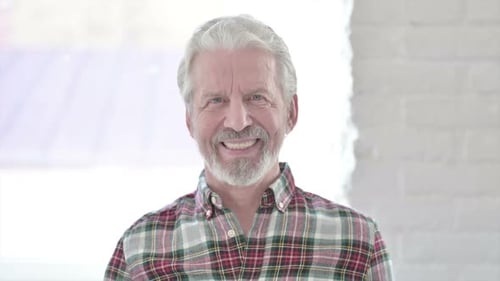 Senior Man With Grey Hair Smiling at the Camera