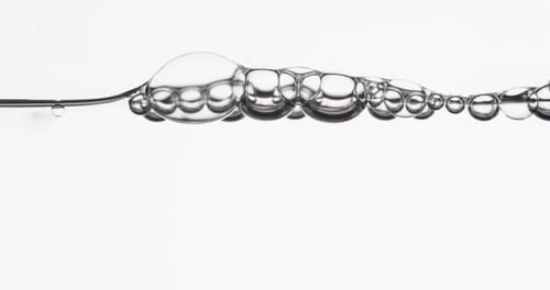 Water Surface Moving As Liquid Pours In And Creates Bubbles