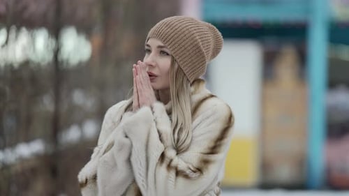 Adult Woman Is Feeling Cold During Walk in City at Winter Day Warming Palms