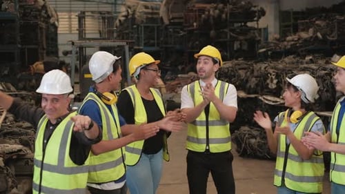 Various ethnics workers and engineers in factory warehouse.