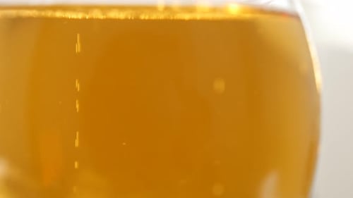 Close-up Of Sparkling Amber Beverage With Bubbles