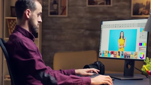 Man Works on Computer in Home Office