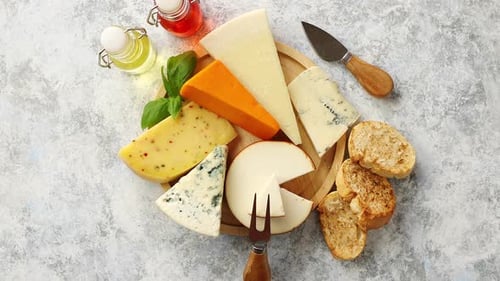 Delicious Assorted Cheeses on Board with Bread