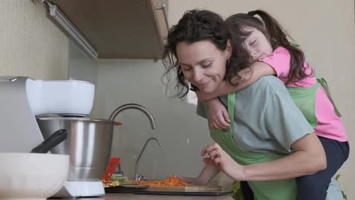 Woman Cooking with Child on Back