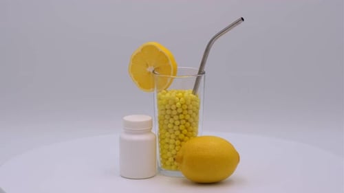 Vitamin C Capsules with Lemon Slice and Pill Bottle