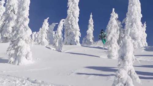 A man skiing down a snow-covered mountain in the winter