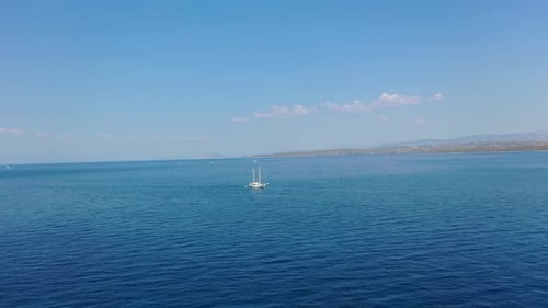 Sail Yacht Cruising on Deep Blue Sea Water at Summer Day