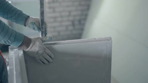 Construction Worker Applying Plaster with Trowel