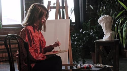 Young Adult Painting Art in a Home Studio