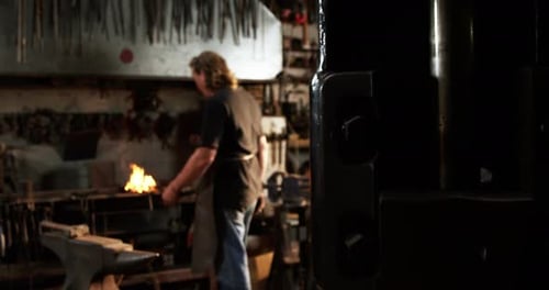 Blacksmith working at workshop