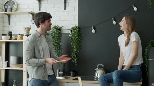 Happy Couple Interacting in Their Modern Kitchen
