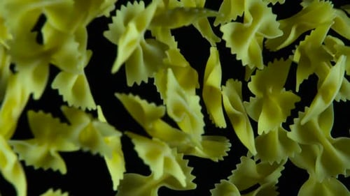 Farfalle Pasta Floating on Black Background