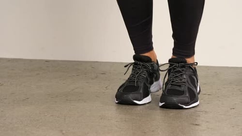 Person Exercising Performing Jumping Jacks Indoors