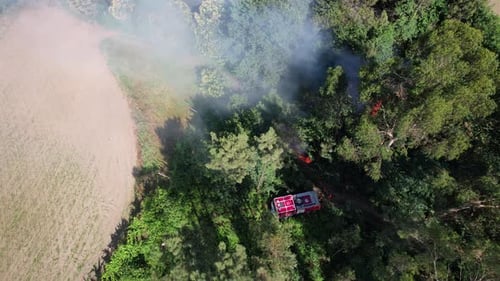 Firetruck Spraying Water on Wildfire from Above