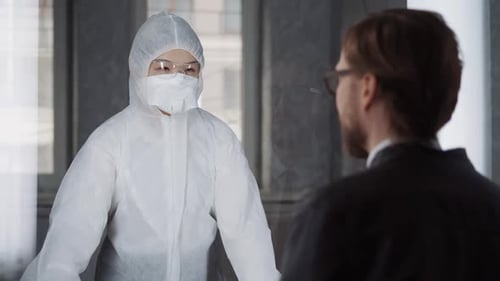 Man Communicates with a Asian Woman Through Glass Put Their Hands to the Glass a Quarantine Zone