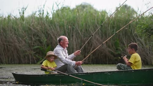 Family Weekend at Pond Fisherman Puts on Glasses to Untangle the Fishing Rods While Sitting in the