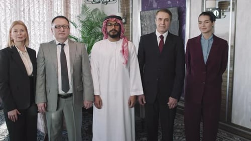 Business People in Suits and Traditional Thobe