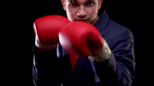 Man in Suit with Boxing Gloves Fighting