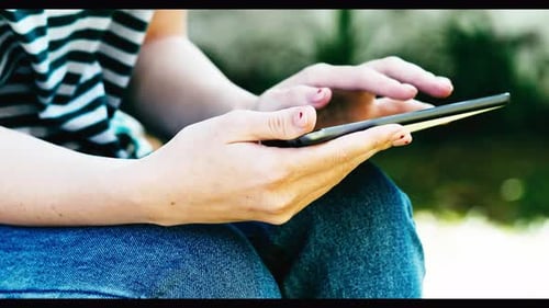 Close-up of woman using tablet