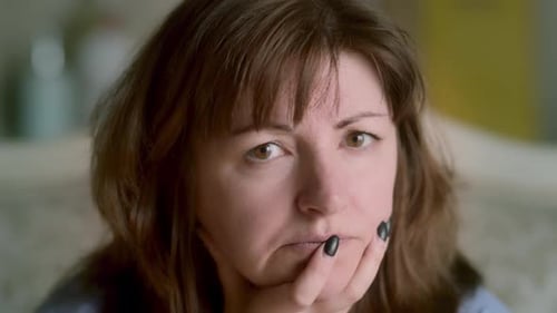 Woman Looking at Camera Resting Chin in Palm