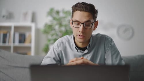 Young Adult Male in Video Conference at Home
