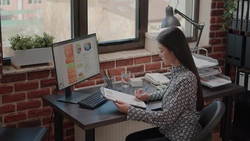 Woman Analyzing Data in an Office Workplace