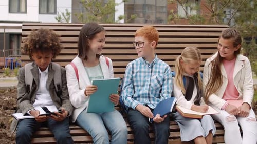 Diverse Children on Bench Chatting After School