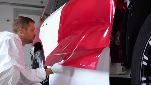 Car Worker Laying Vinyl Wrap