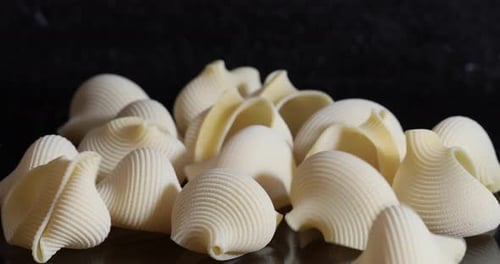 Dry Shell Pasta Pile Close Up on Black