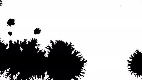 Ink Blots Spreading Across White Surface