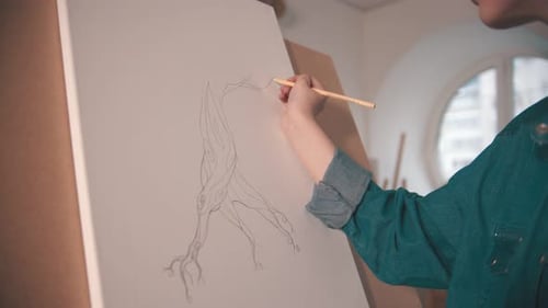 A Young Woman Sketching an Abstract Tree on the Canvas