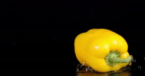 One Yellow Sweet Pepper Rotating on the Table.
