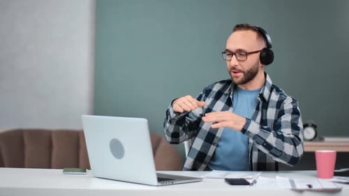 Man Talking at Laptop During Video Conference