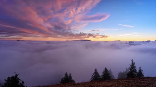 Scenic Sunrise Over Mountain Landscape with Moving Clouds
