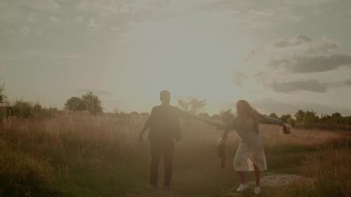 Carefree Young Couple Walking and Smiling on Holiday on Countryside Freedom and Happiness Concept