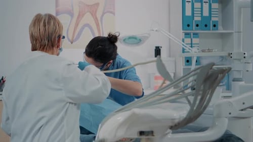 Dentists Working on Patient in Bright Clinic