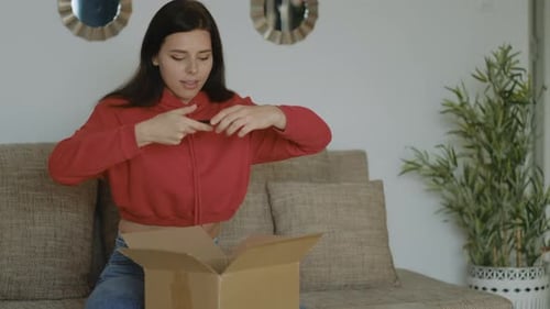 Woman Taking Pictures of Box with her Phone
