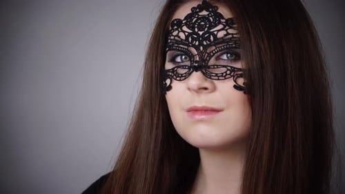 Woman Wearing Elegant Lace Mask in Studio