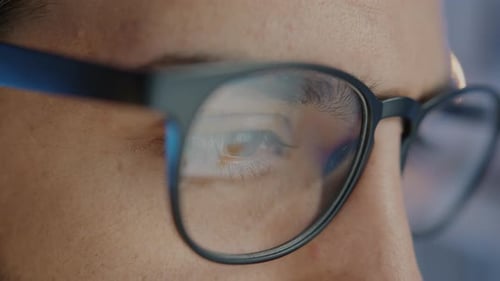 Closeup Portrait of Young Middle Eastern Man Wearing Eyeglasses Working in Office at Night