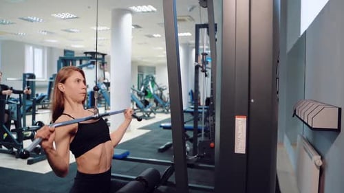 Woman Doing Lat Pulldowns at the Gym