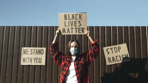 Person Protesting for Black Lives Matter in Urban Setting