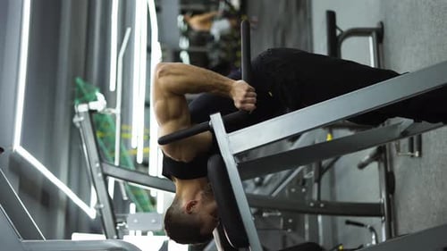 Athlete Man Training Force Push Up and Pull Up Exercise on Bars in Gym