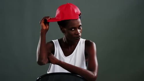 Stylish Woman Posing with a Red Baseball Cap