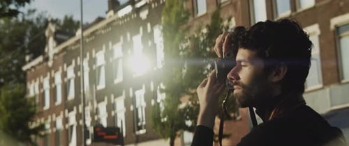 Young Adult Taking Pictures with Vintage Camera