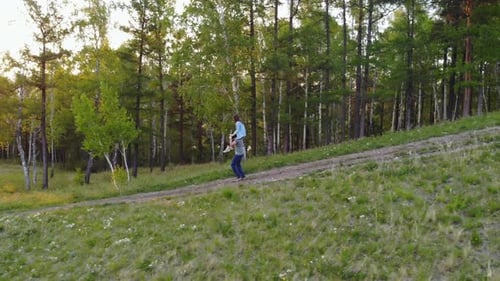 Aerial Shot of a Couple Walking on a Mountain Path.