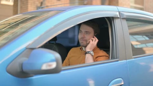 Man Arguing on Phone in Car