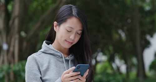 Woman Use of Mobile Phone in The Park