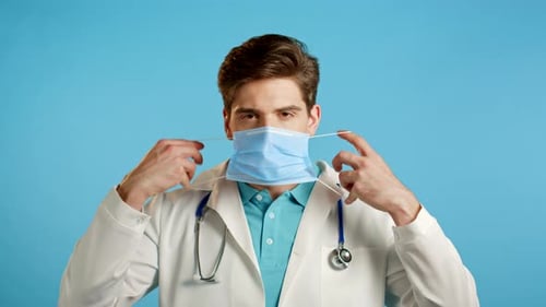 Doctor Putting On a Surgical Mask