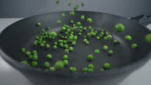 Green Peas Fall in Slow Motion To the Pan, Fresh Vegetables Are Falling